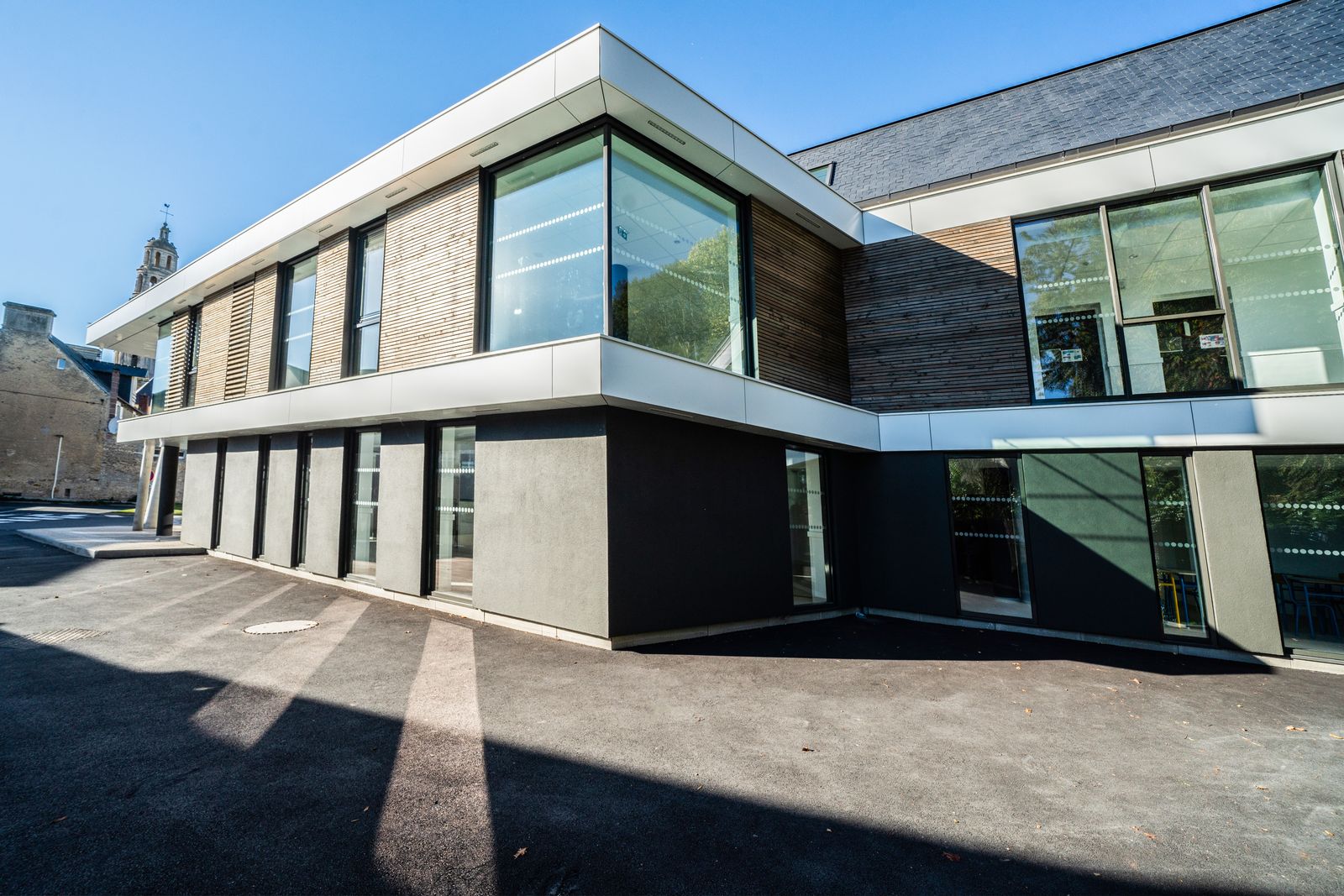 Contemporary school building, timber cladding and white façade