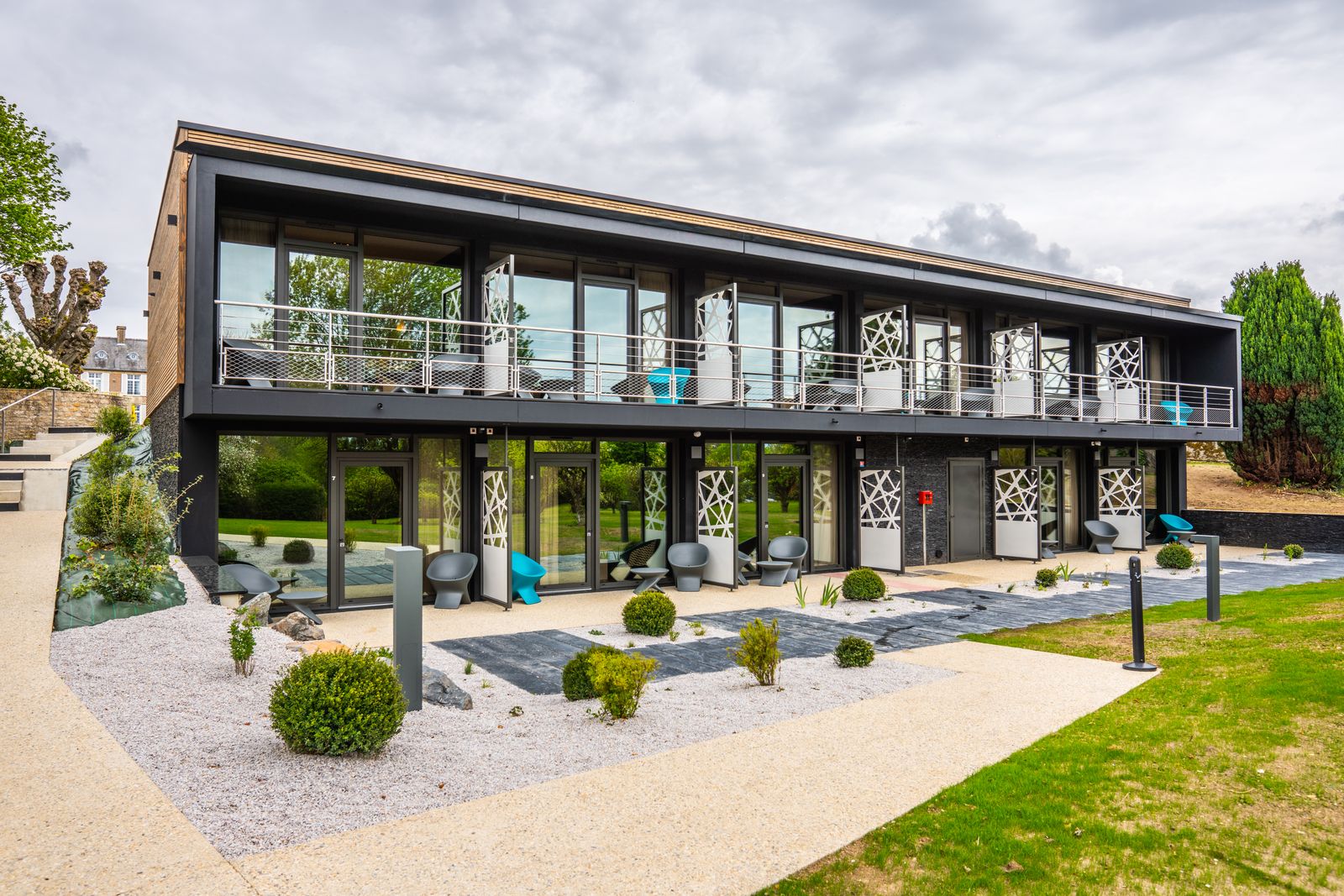 Contemporary timber and metal hotel, seen from the garden