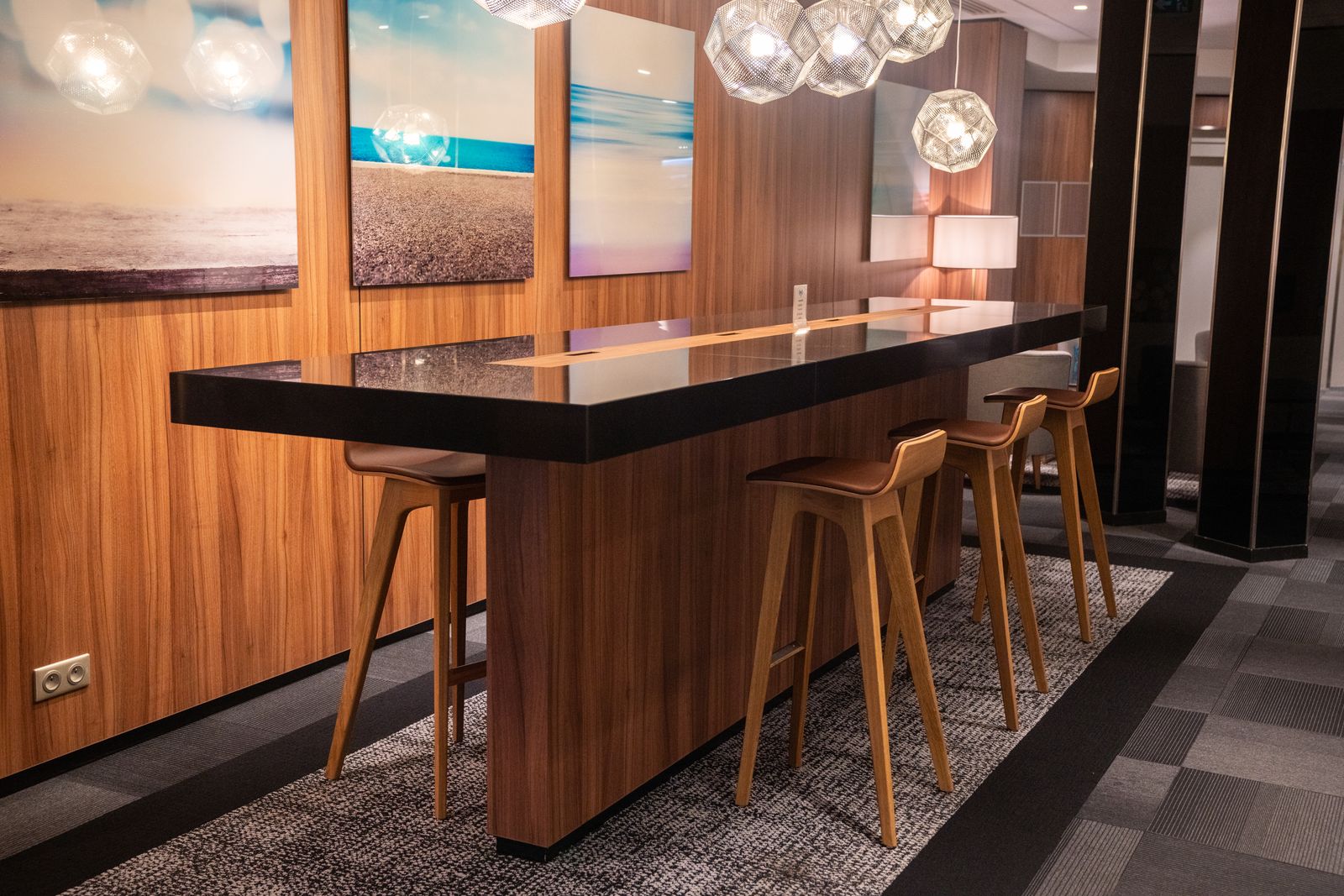 Wooden high table and pendant lights in a hotel