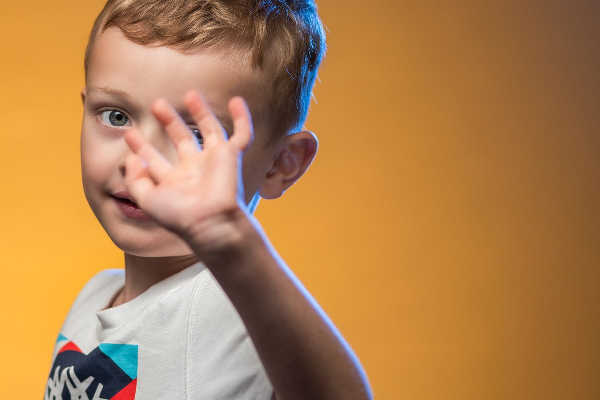 Portrait enfant main fond jaune lumière bleue — Arnaud Chapelle Photographe